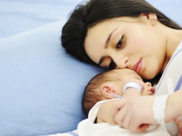 Woman holding her newborn baby at hospital