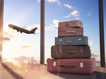 travel bags and airplane in sky