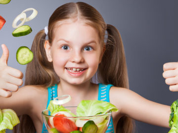 Beautiful girl with fresh vegetables